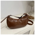 Detail of caramel brown crescent bag with adjustable silver buckle and glossy finish - Brown