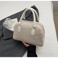 Detailed close-up of beige suede bowling bag with smooth leather handles and silver zipper - Off White