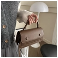 Detail of vintage brown crossbody bag featuring woven texture and decorative buttons - Brown