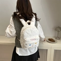 Cute white plush backpack for women with pink fashion embroidery shown on model - White