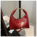 Detail of red patent leather hobo bag with embossed logo and golden metal buckle - Red