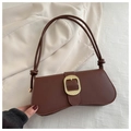 Detailed shot of retro brown leather bag featuring large gold woven square buckle and knot strap - Brown