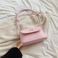 Pink crossbody bag with silver metal bow and knotted strap design for a stylish look - Pink