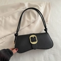 Minimalist black baguette shoulder bag with textured gold buckle and knotted strap detail - Black
