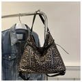 Detail of leopard print tote bag featuring silver vertical zippers and slim black straps - Tan
