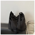 Detail of minimalist black nylon tote with drawstring closure and adjustable strap - Black