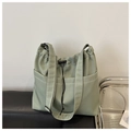 Detail of adjustable wide strap and side pockets on sage green large capacity tote bag - Green