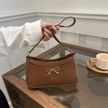 Brown faux leather crescent underarm bag with a golden metal bow buckle detail - Brown