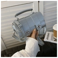 Detail of silver crocodile pattern cylinder bag with dual metallic twist locks and handle - Silver