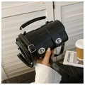 Detail of black crocodile texture cylinder handbag with silver twist locks and top handle - Black