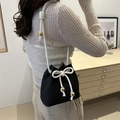 Minimalist black knit bucket bag with white drawstring rope and gold bead accents - Black