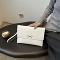White faux leather envelope clutch bag with silver metal bow and wrist strap - White