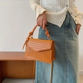 Caramel orange crocodile embossed leather handbag with knotted handle and shoulder strap - Tan