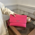 Hot pink leather envelope clutch bag with silver bow detail and wristlet strap - Rose Pink