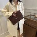 Dark brown envelope clutch with silver bow detail and a detachable wrist strap - Brown