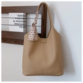 Detail of camel hobo tote bag featuring lychee grain texture and a decorative scarf handle - Khaki