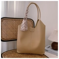 Detail of khaki tote bag with litchi texture, fashion label and decorative silk scarf - Khaki