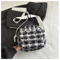 Detail of checkered canvas bag featuring black heart prints and wide woven shoulder strap - Black