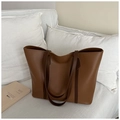 Detailopname van de minimalistische grote bruine kunstlederen shopper op een witte bank - Tan