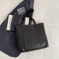 Minimalist black leather tote bag with vertical stitching and long shoulder handles - Black
