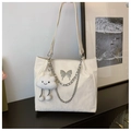 Detail of off-white tote bag with silver butterfly charm and plush cloud accessory - Beige (With Cloud Pendant)