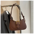 Detail view of brown matte leather croissant bag with a gold buckle and knotted shoulder strap - Brown