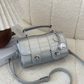 Silver cylindrical faux crocodile texture handbag with dual metallic twist locks - Silver (With Charm)