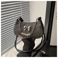 Macro detail of dark grey denim moon bag featuring a silver bow and pearl chain strap - Black