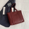 Minimalist burgundy faux leather tote bag with vertical straps and small front pocket - Burgundy