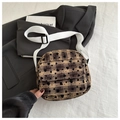 Detail of vintage plaid crossbody bag with black heart flocking and white canvas strap - Brown
