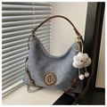 Detail of grey canvas tote bag with brown straps, metal M logo and plush cloud charm - With Pendant / Blue