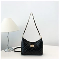 Detail of black quilted chain tote bag with golden lock on minimalist white desk - Small (24x18x7cm) / Small Black