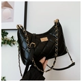 Detailed view of black quilted leather shoulder bag featuring a gold rotating square lock - Small / Black