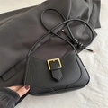 Minimalist black leather shoulder bag with gold buckle on a stylish suit fabric - Black