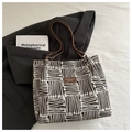 Large tote bag with black and white geometric lines and brown leather handles - Coffee Without Charm
