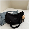 Détail du sac cabas en nylon noir avec patch fashion, bandoulière et breloque - Noir avec pendentif