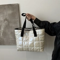 Chic white quilted shoulder bag with black strap handles and silk satin texture - Off White