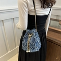 Denim bucket bag with frayed quilted pattern, gold chain strap, and pearl charms - Blue