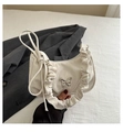 Detail of white pleated crescent bag with silver butterfly buckle and ruffle edge trim - White