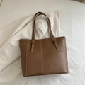 Dark brown matte leather tote bag with white contrast stitching and buckle handles - Brown