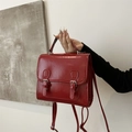 Classic burgundy retro backpack with dual buckle straps and polished silver hardware - Red