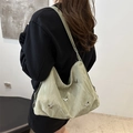Light green pleated nylon shoulder bag with silver butterfly charms worn by a model - No Pendant / Green