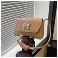 Close-up of beige PU leather shoulder bag with silver bow buckle and decorative knotted strap - Khaki