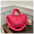 Detailed view of quilted puffer bag in bright pink with soft padded shoulder straps - Rose Pink