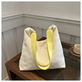 Dettaglio della trama a rombi intrecciata gialla e bianca sulla borsa trendy chic - Giallo