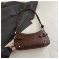 Detail of dark brown leather underarm bag with silver studs and knotted shoulder strap - Brown