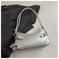 Detail of silver handbag featuring metallic rivets and stylish knotted handle design - Silver