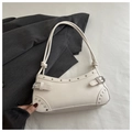 Detail of off-white baguette bag featuring metal studs and decorative buckle on a blazer - White