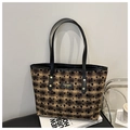 Close-up of black plaid tote bag featuring heart prints and a fashion logo patch - Plaid Brown (Heart Pattern)