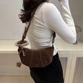 Dark brown suede croissant shoulder bag with pleated details and knotted strap design - Dark Brown